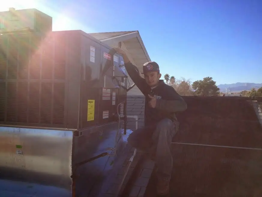 HVAC technician performing HVAC Inspection on a rooftop unit in Findlay